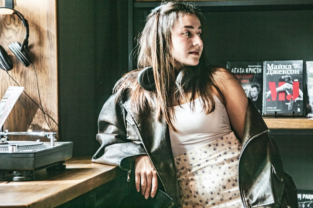 Young woman recording a podcast episode with a pop filter microphone