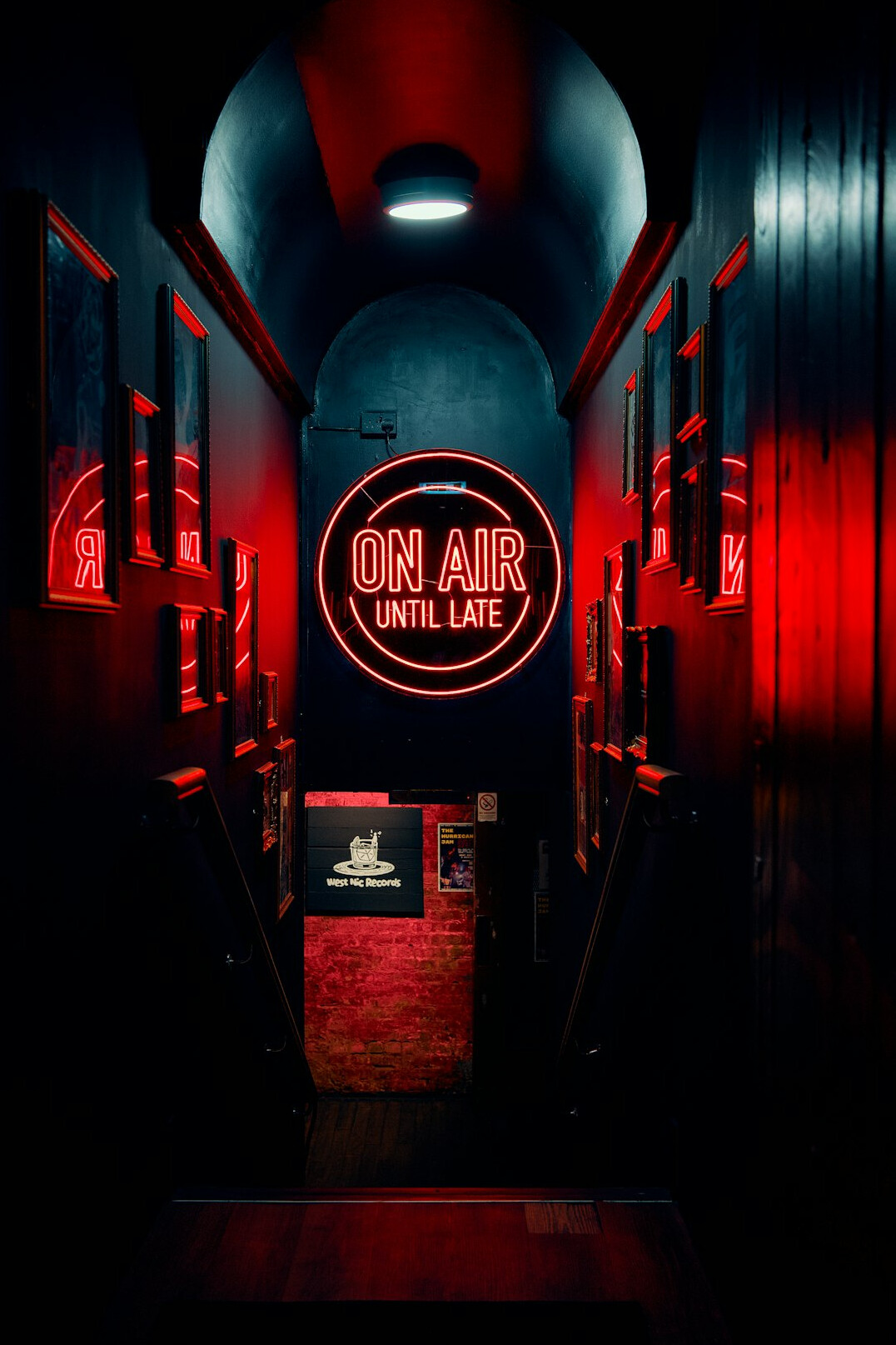 Radio broadcasting control room with illuminated mixing console and on air sign